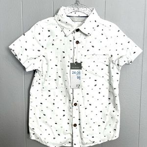 Toddler cotton short-sleeved button down with planets and stars detail.